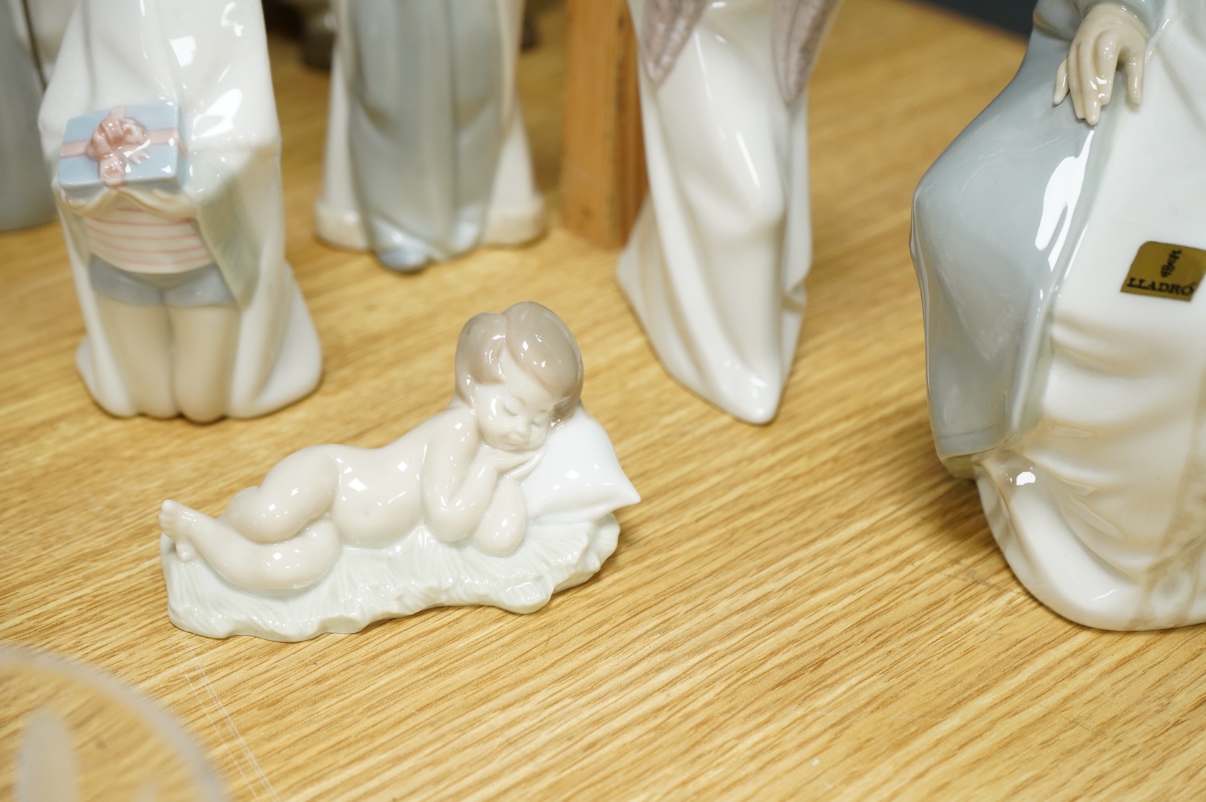 A group of Lladro figures Lord & Lady and a Chancellor, 3 Kings, Joseph with Staff and a recumbent child (8)